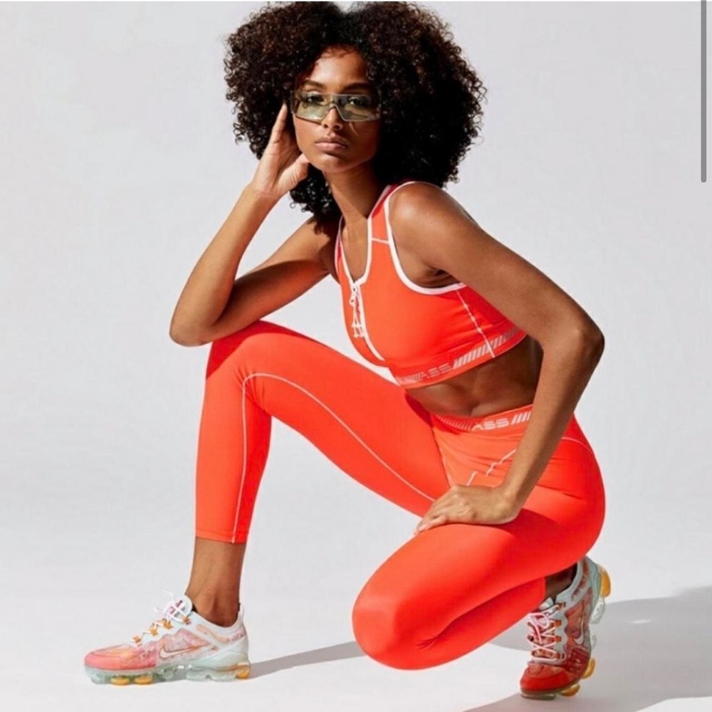 Adam Selman Sport Orange zip crop top and French cut leggings